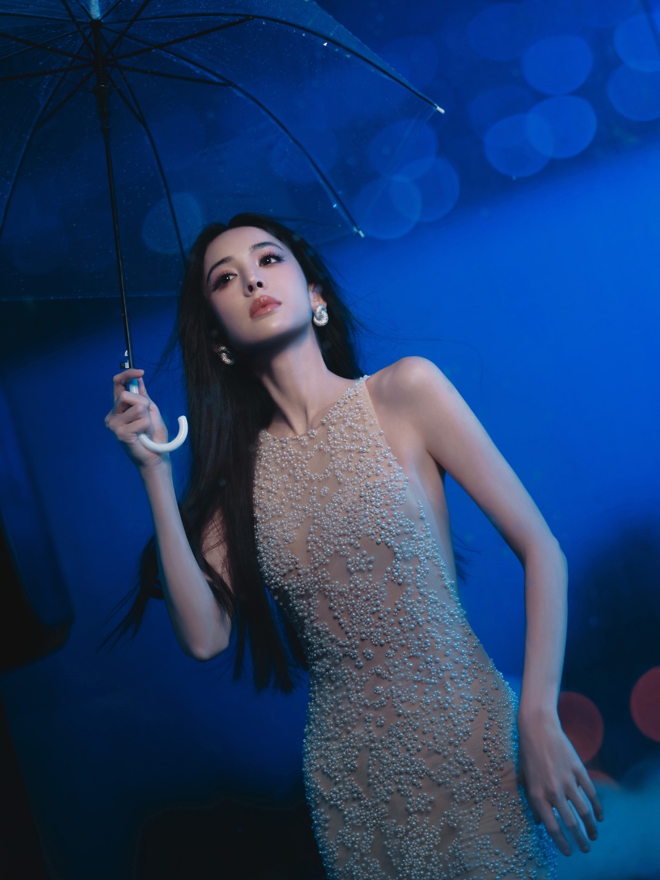 古力娜扎在霓虹与雨幕之间 玻璃映出城市的棋盘